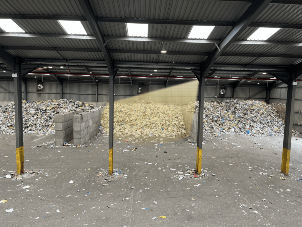 Waste stored in bunkers with graphic overlay showing LiDAR sensor field of view – part of a smart waste management solution