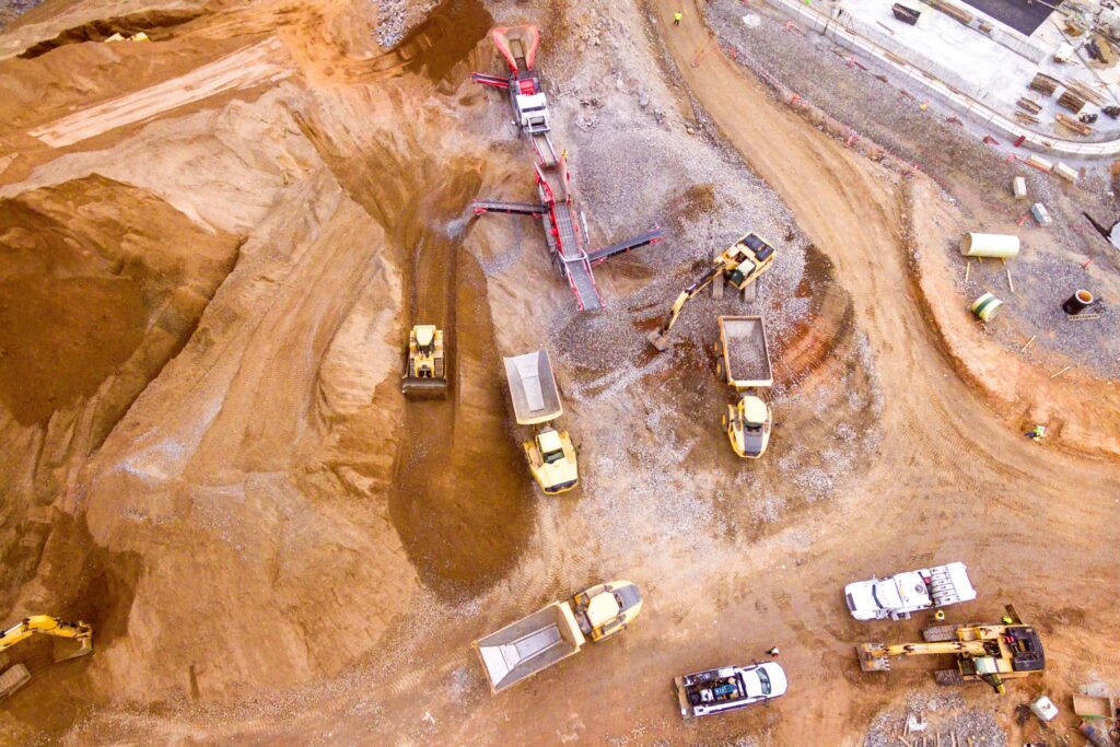 Mining site with trucks and extracted bulk materials being loaded – stockpile measurement for efficient resource tracking